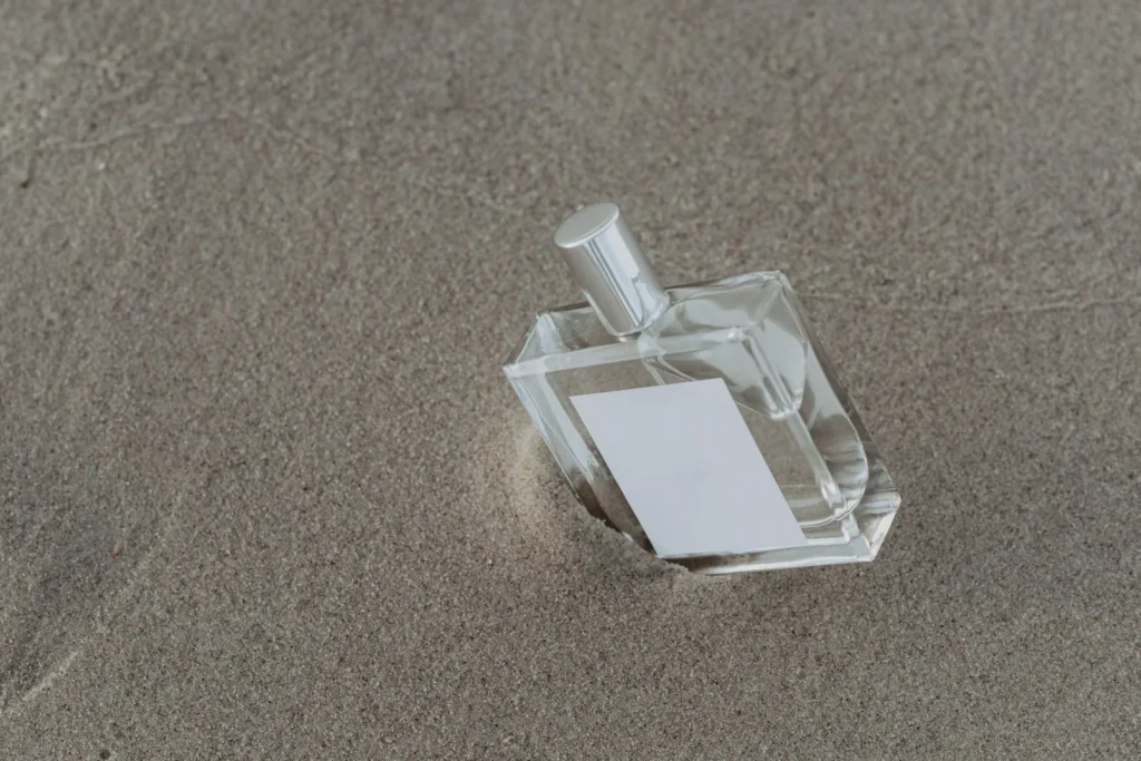 Parfumflakon auf Sand – fruchtiger Sommerduft wie Xerjoff Erba Pura